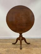 A George III mahogany snap top table, the circular top above bird cage, baluster turned column and
