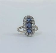 A striking sapphire and diamond cocktail ring in the Art Deco taste, c. 1930, the oval plaque