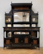An Aesthetic period ebonised mirror back display cabinet in the style of Edward William Godwin, c.