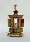 A 1960's American novelty musical cigarette dispenser in the Rococo taste, cast metal and brass