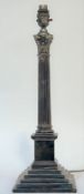 An Edwardian silver-plated Corinthian columnar table lamp (converted from an oil lamp), on a