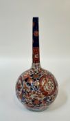 A Japanese Imari porcelain bottle vase, probably late 19th century, the spherical body beneath a