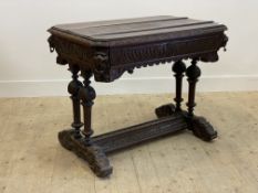 A Victorian oak centre table of Jacobean design, the rectangular top with canted corners over