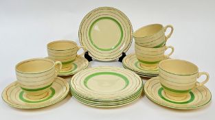 Clarice Cliff for Newport Pottery, a green painted and gilt part tea service comprising five cups (