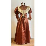 Antique textiles: a Victorian rust/brown silk two piece lady's day dress, the jacket with ruched