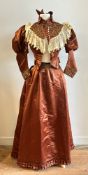 Antique textiles: a Victorian rust/brown silk two piece lady's day dress, the jacket with ruched