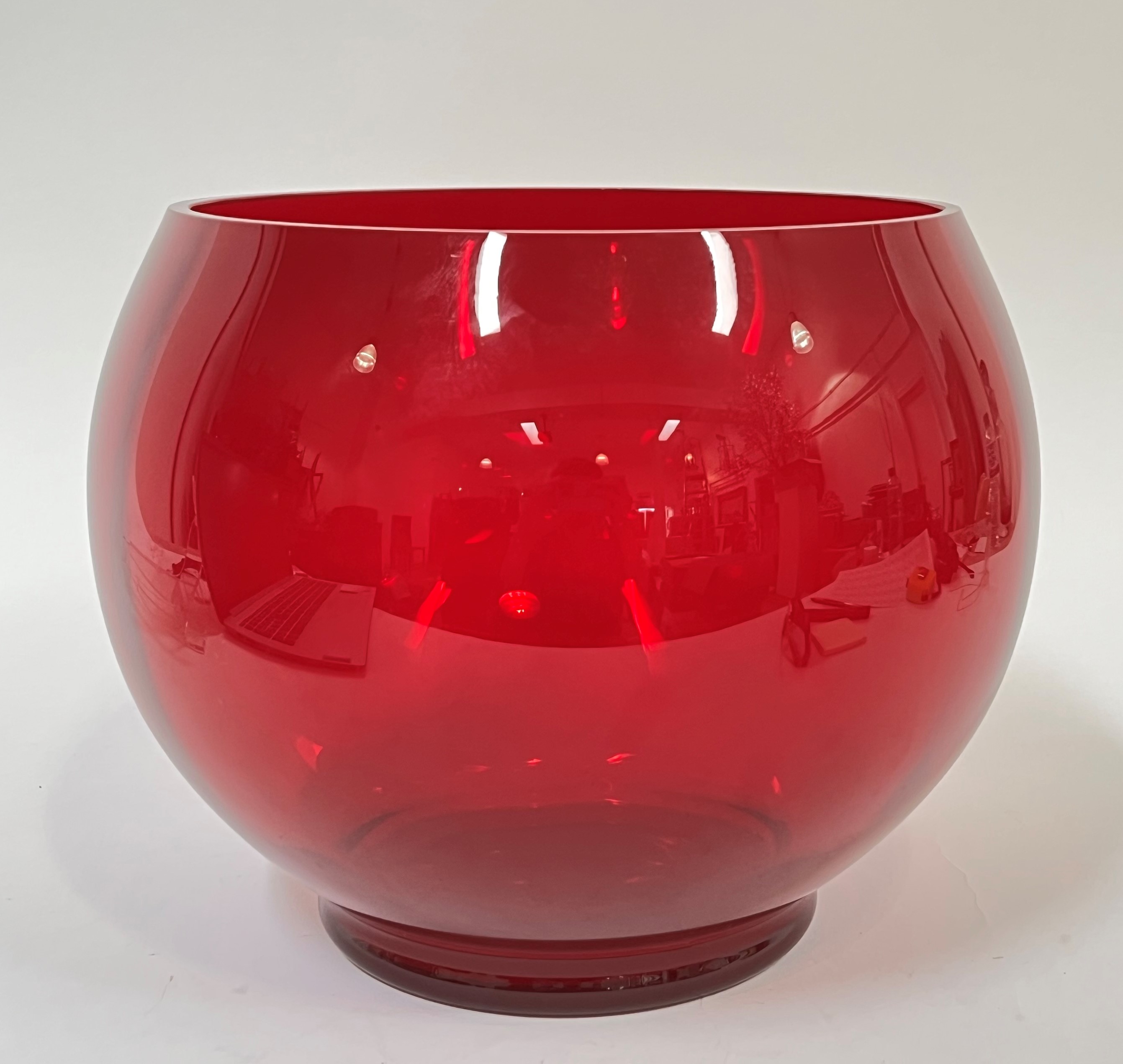 A large decorative red glass vase of globular form on squat foot (h- 23cm, w- 31cm)