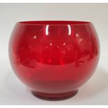 A large decorative red glass vase of globular form on squat foot (h- 23cm, w- 31cm)