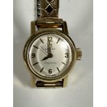 An Omega gold lady's Ladymatic vintage wristwatch with enamelled dial with arabic numerals at