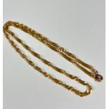 An Eastern style yellow metal spiral twist chain necklace with metal clasp fastening, unmarked (