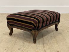A Victorian style walnut footstool, the top upholstered in striped cut velvet, raised on floral