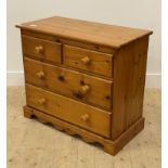 A late 20th century polished pine chest, fitted with two short and two long drawers, raised on