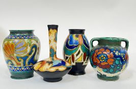 A group of four Gouda pottery miniature vases comprising a squat vase with abstract decoration