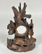 A 19thc Black Forrest carved wood pocket watch stand with eagle surmount, the central pierced
