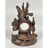 A 19thc Black Forrest carved wood pocket watch stand with eagle surmount, the central pierced