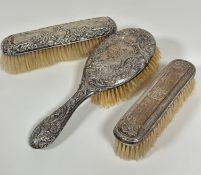 A Birmingham silver chased hairbrush with C scroll ribbon and floral design, some areas of wear to