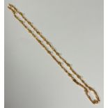 A 9ct gold fluted ball and open oval scrolling link 9ct gold chain necklace with lobster claw