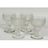 A set of four late 19thc/early 20thc red wine glasses with engraved vine, fruit and leaf decoration,