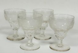 A set of four late 19thc/early 20thc red wine glasses with engraved vine, fruit and leaf decoration,