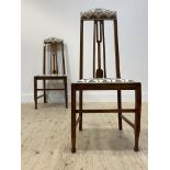 A pair of Arts and Crafts period oak side chairs in the manner of E.A. Taylor, upholstered crest