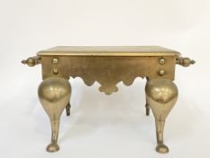 A large brass footman, 19th century, the rectangular top with moulded edge above a shaped apron