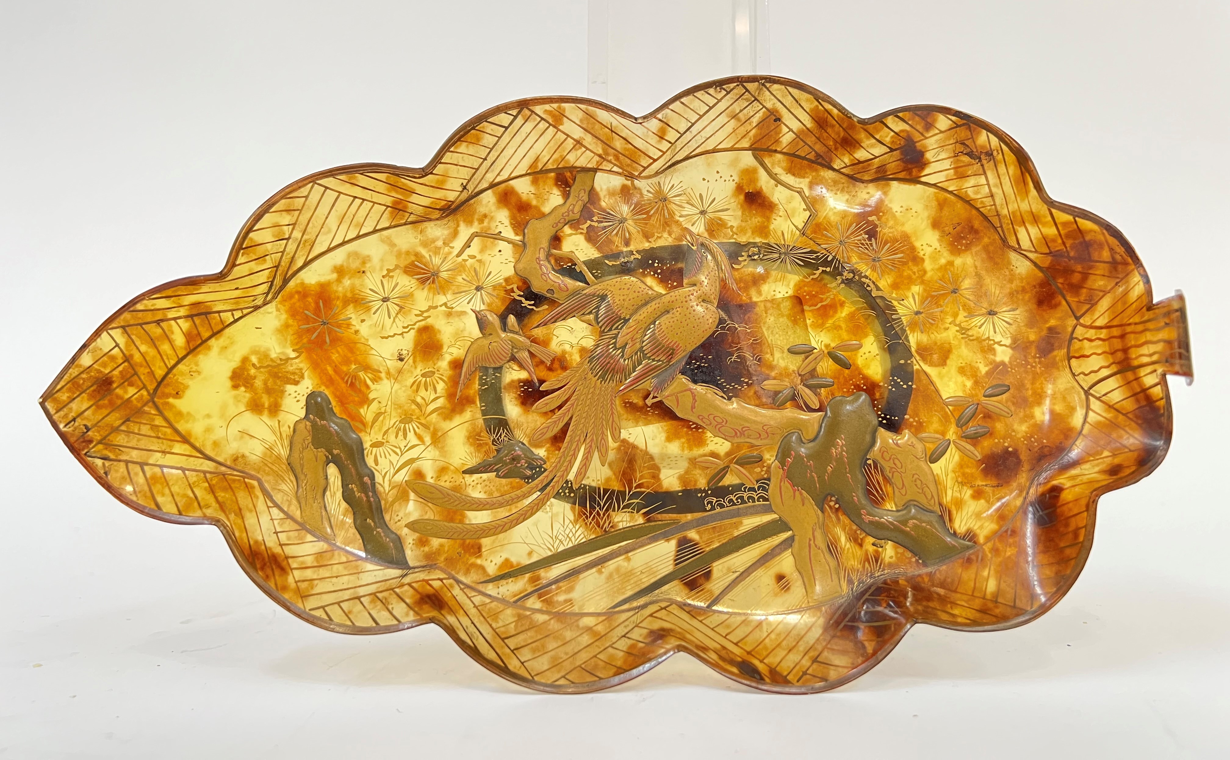 A Japanese lacquered faux tortoiseshell dish in the form of a leaf, decorated with scene of birds