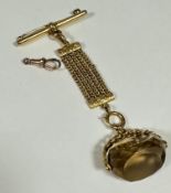 A 9ct gold mounted revolving seal fob on fine mesh suspension with engraved decoration, complete