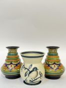 A pair of Gouda vases decorated in bright colours on a black ground (marked verso) (h- 15cm),