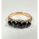 A yellow metal five stone graduated sapphire ring of mixed old cuts, largest approx 0.2ct, in