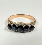 A yellow metal five stone graduated sapphire ring of mixed old cuts, largest approx 0.2ct, in