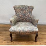 A late Victorian drawing room armchair, the serpentine back, arms and seat upholstered in cotton