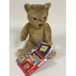 An early 20thc blonde plush mohair teddy bear with inset plastic bead eyes, composition nose and