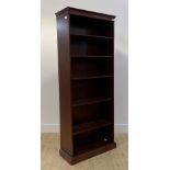 A Georgian style mahogany open bookcase, with dentil cornice over four adjustable shelves, raised on