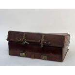 A early 20thc brown leather suitcase with brass locks, with linen fitted interior and leather