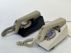 A pair of two toned trim dial phones, one with a black base and beige phone the other with a cream