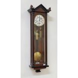 A Victorian Vienna style regulator wall clock, the ebonised and walnut case with arched pediment