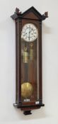 A Victorian Vienna style regulator wall clock, the ebonised and walnut case with arched pediment