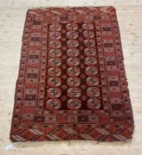 A Turkoman Bokhara rug, three rows of guls within a deep border 130cm x 200cm