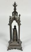A cast metal figure of Madonna with Infant Jesus, with arched canopy and spiral turned columns, on