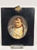 An early 19thc papier mache portrait miniature frame with overpainted print of Napoleon with gilt