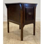 An early 20th century mahogany filing cabinet, the single panelled drawer opening to multiple