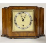 An Elliott Art Deco period walnut cased mantel clock, the silvered dial with Roman chapter ring