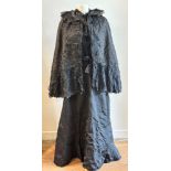 Antique textiles: a Victorian lady's black mourning jacket, skirt and cape, the cape with ruched