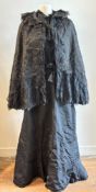 Antique textiles: a Victorian lady's black mourning jacket, skirt and cape, the cape with ruched