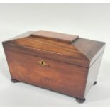 A 19thc mahogany sarcophagus tea caddy, the hinged top enclosing a fitted interior, with open centre