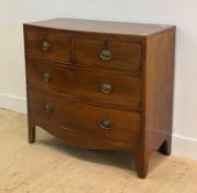 A Georgian mahogany bow front chest, fitted with two short and two long drawers, raised on splayed