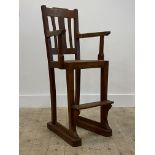 A late 19th / early 20th century stained oak high chair, with cane seat panel, square tapered