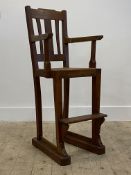 A late 19th / early 20th century stained oak high chair, with cane seat panel, square tapered