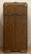 An Art Deco period figured and cross banded wardrobe compactum, twin doors opening to shelves and