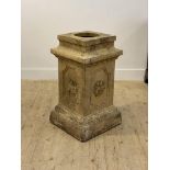 A 19th century fire clay pedestal of rectangular outline, the panelled case moulded with cherubs,